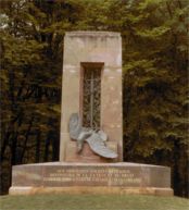 Alsatian monument to French soldiers. Compigne. Glade of the Armistice. At three PM on June 21, 1940, Hitler walked past this memorial, its skewered eagle bedecked with red Reich flags bearing black swastikas.
